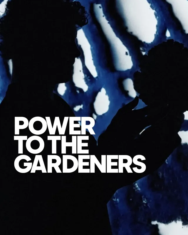 A Gardener in silhouette holding a coral: Power to the Gardeners
